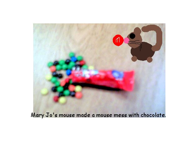 mouse on a table with m&m's